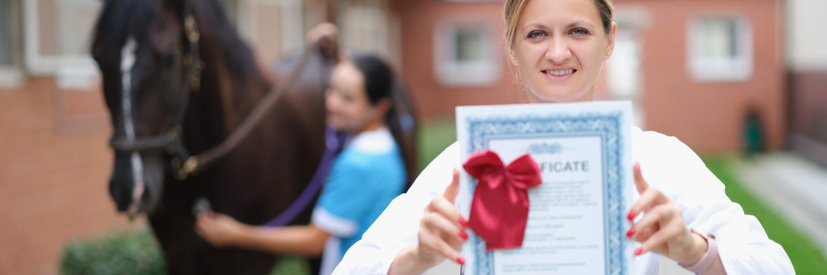 Person holding a certificate with a horse and handler in the background.