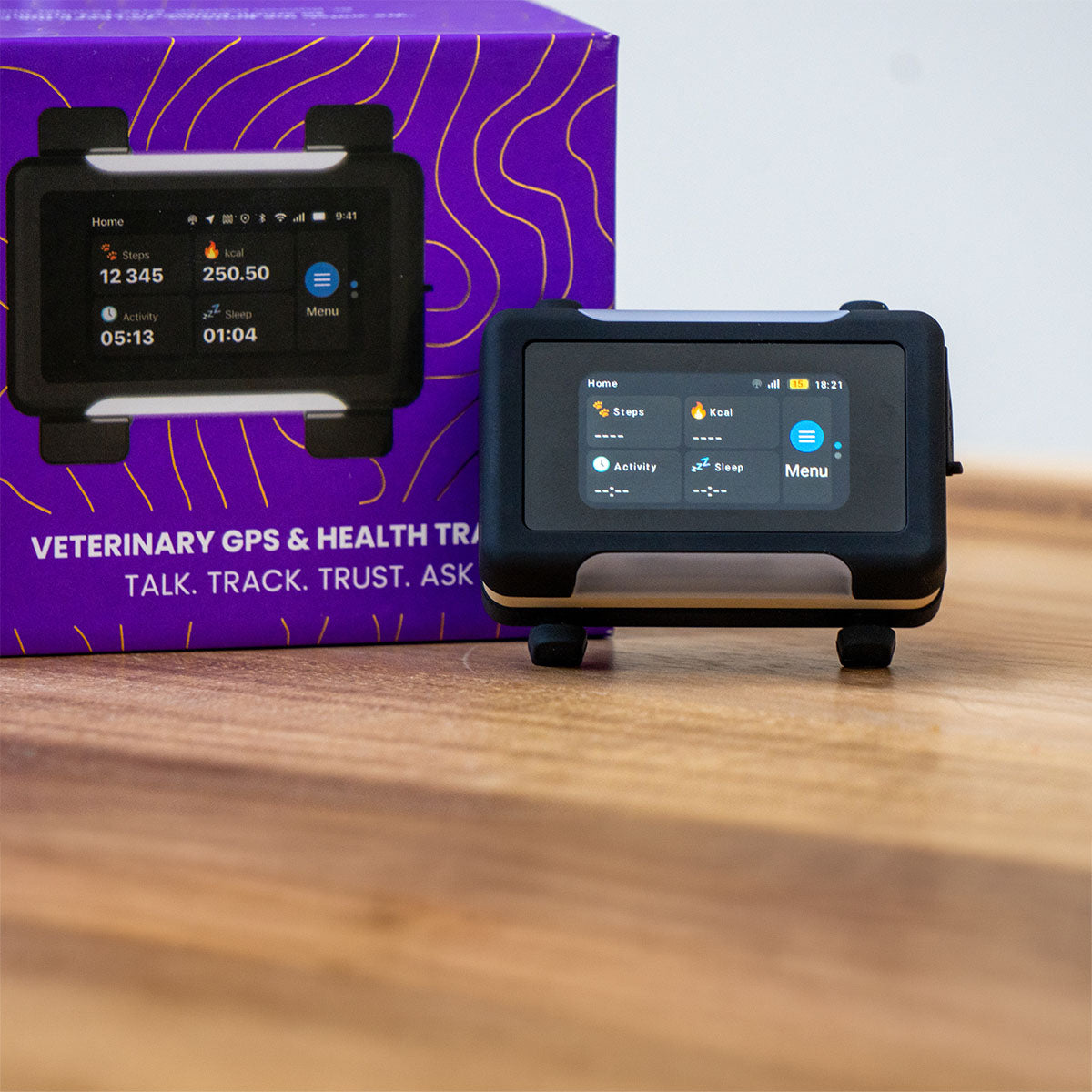 Black / Gold | Smart GPS & Health Tracker: Close-up of the Black / Gold tracker in front of its purple box