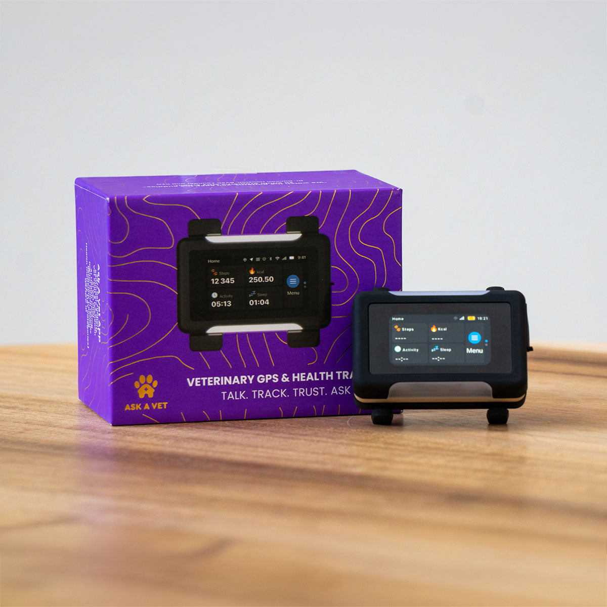 Black / Gold | Smart GPS & Health Tracker: The Black / Gold tracker beside its purple box, seen from further back